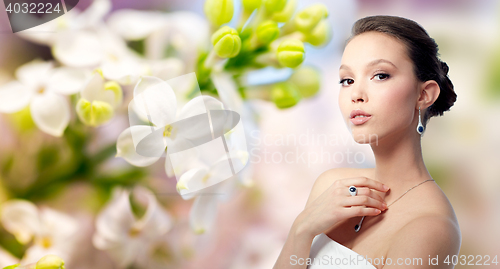 Image of beautiful woman with earring, ring and pendant