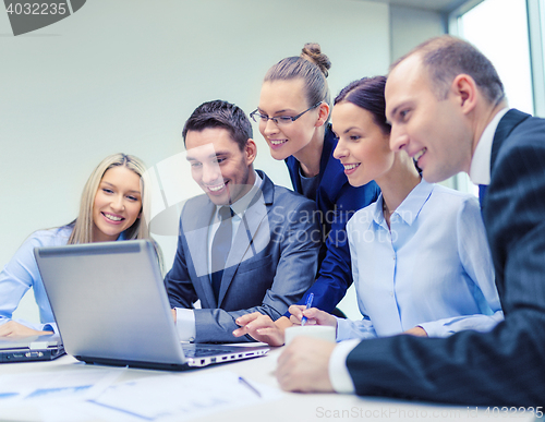 Image of business team with laptop having discussion