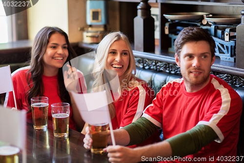 Image of fans or friends watching football at sport bar