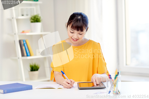 Image of asian woman student with tablet pc at home