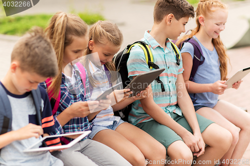 Image of group of happy elementary school students talking