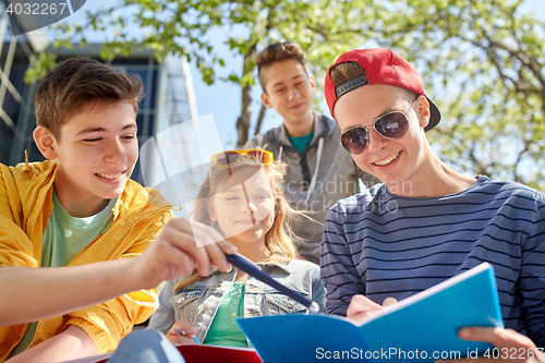 Image of group of students with notebooks at school yard