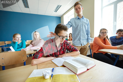 Image of classmate offending student boy at school