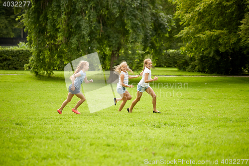 Image of happy kids running and playing game outdoors