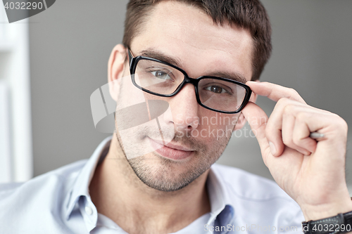 Image of portrait of businessman in eyeglasses at office