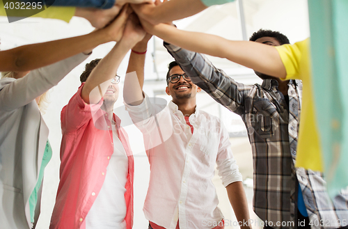 Image of group of international students making high five