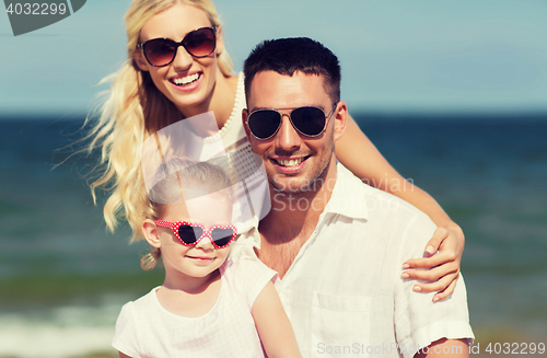 Image of happy family in sunglasses on summer beach