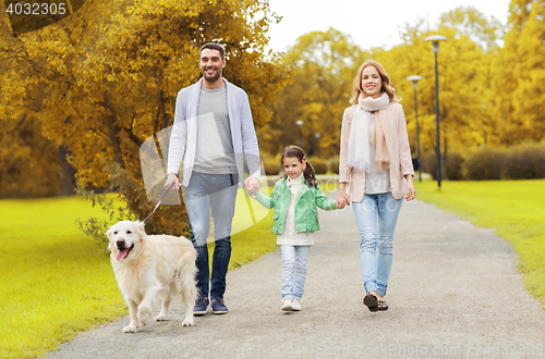 Image of happy family with labrador retriever dog in park