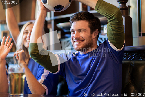 Image of football fans or friends with beer at sport bar