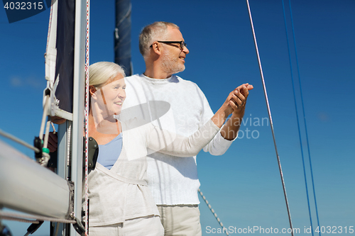 Image of happy senior couple on sail boat or yacht in sea