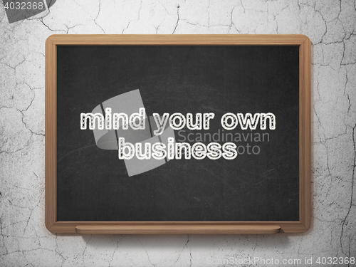 Image of Finance concept: Mind Your own Business on chalkboard background