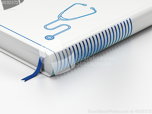 Image of Healthcare concept: closed book, Stethoscope on white background