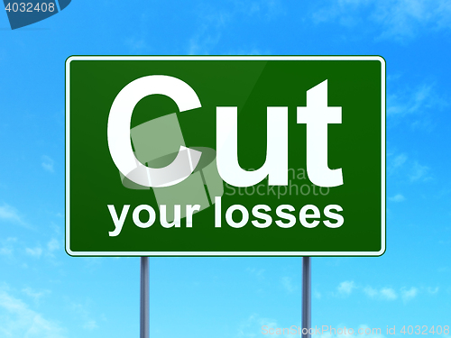 Image of Finance concept: Cut Your losses on road sign background