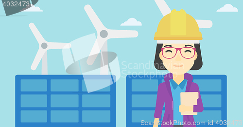 Image of Female worker of solar power plant and wind farm.