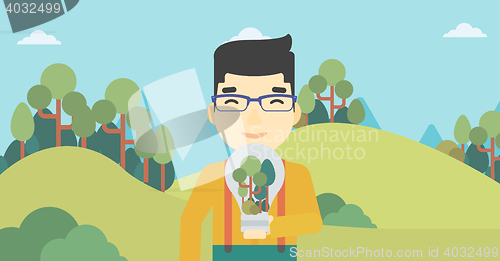 Image of Man with lightbulb and trees inside.