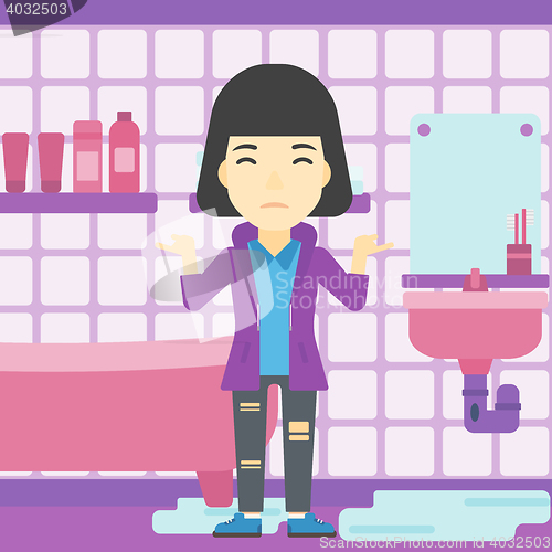 Image of Woman in despair standing near leaking sink.