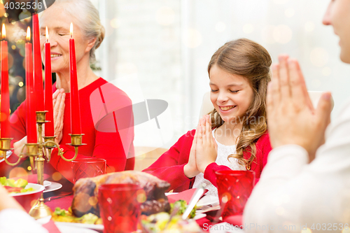 Image of smiling family having holiday dinner at home