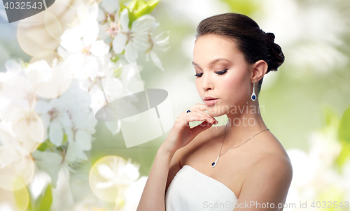 Image of beautiful woman with earring, ring and pendant