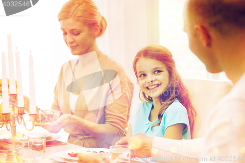 Image of smiling family having holiday dinner at home