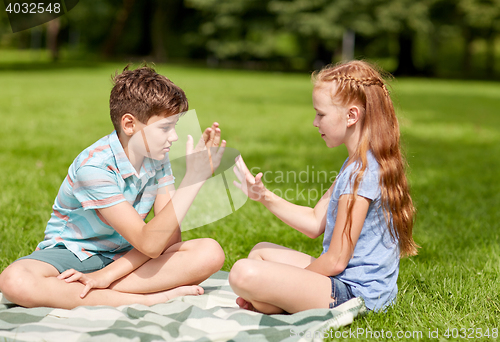 Image of happy kids playing rock-paper-scissors game