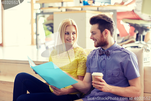 Image of office workers with folder and coffee
