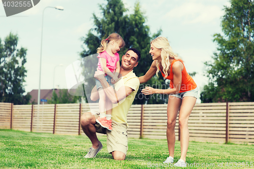 Image of happy family hugging outdoors