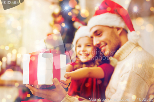 Image of close up of father and daughter with gift box