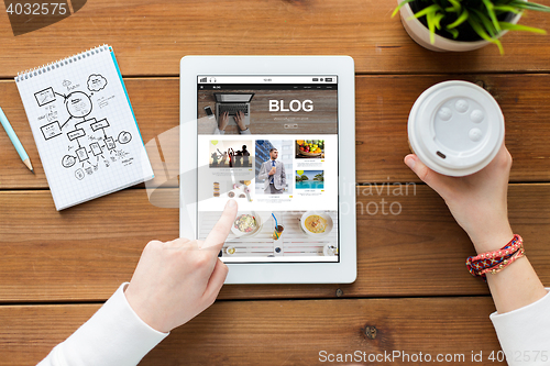 Image of close up of woman with tablet pc on wooden table