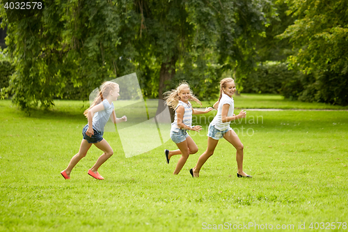 Image of happy kids running and playing game outdoors