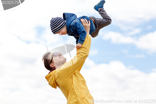 Image of father with son playing and having fun outdoors