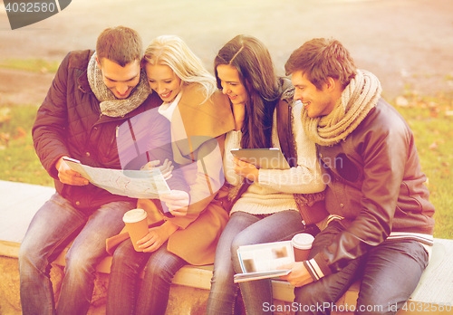 Image of couples with tourist map in autumn park