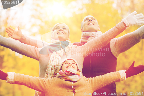 Image of happy family having fun in autumn park