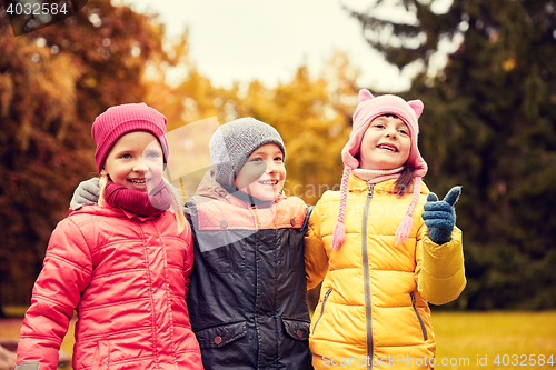 Image of group of happy children hugging in autumn park