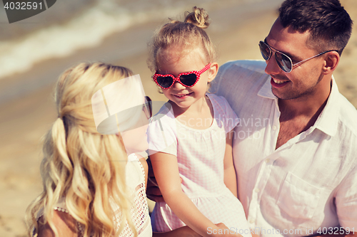 Image of happy family in sunglasses on summer beach