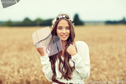 Image of smiling young hippie woman on cereal field