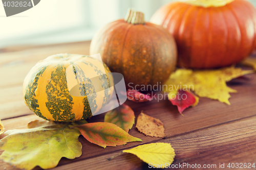 Image of close up of pumpkins on wooden table at home