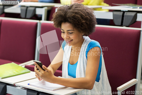 Image of african student girl with smartphone on lecture