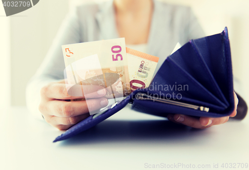 Image of close up of woman hands with wallet and euro money