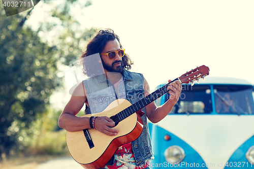 Image of hippie man playing guitar over minivan car outdoor