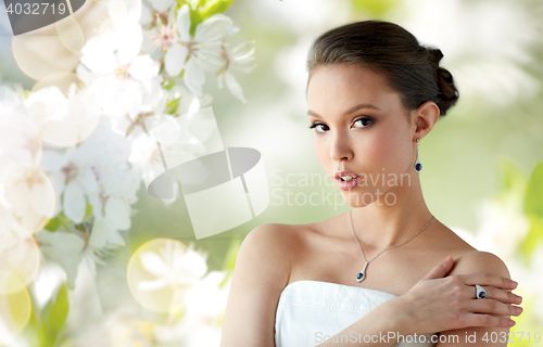 Image of beautiful woman with earring, ring and pendant