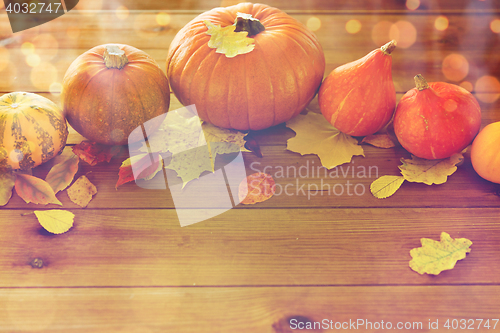 Image of close up of pumpkins on wooden table at home