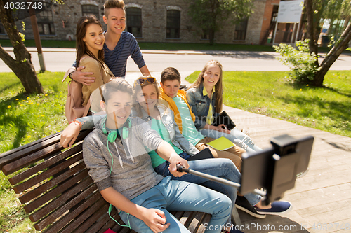 Image of happy teenage students taking selfie by smartphone