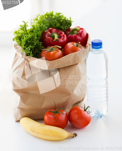 Image of close up of bag with friuts, vegetables and water
