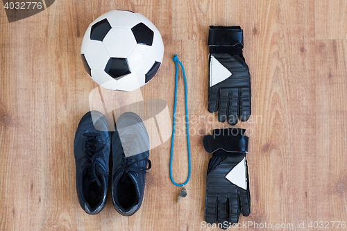 Image of close up of soccer ball, boots, whistle and gloves