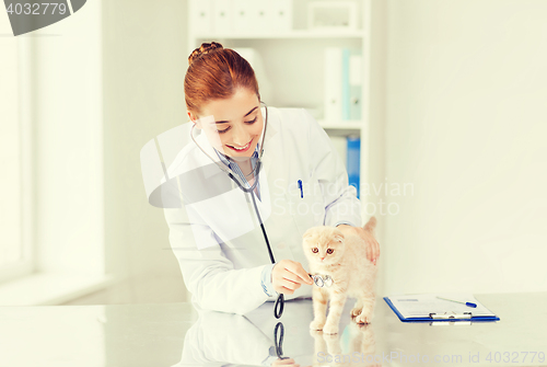 Image of happy veterinarian with kitten at vet clinic