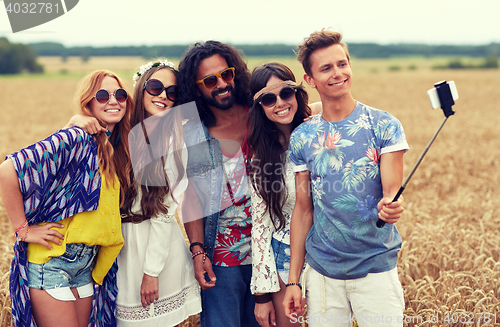 Image of hippie friends with smartphone on selfie stick