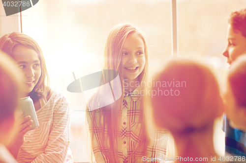 Image of group of school kids with soda cans in corridor