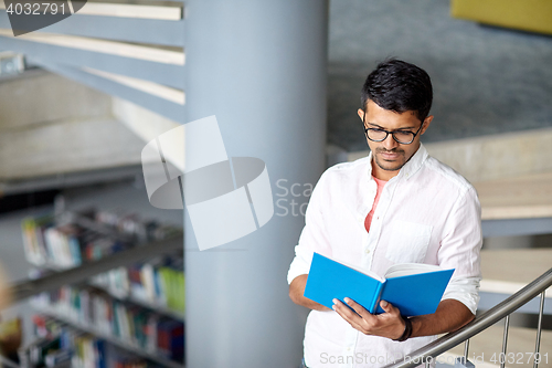 Image of hindu student boy or man reading book at library