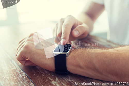 Image of close up of male hands setting smart watch