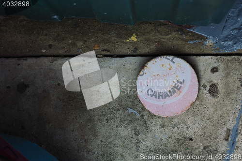Image of Flat round object with caramel word on cement ground